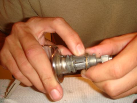 1992 Ford Bronco - Hands manipulate a car's ignition lock cylinder and key.