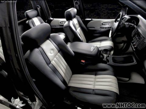 2007 Ford Mustang - The interior features two-tone leather seats with a prominent center console and cup holders.