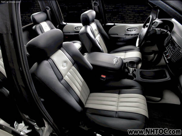 Interior view of a vehicle with two-tone seats and a center console