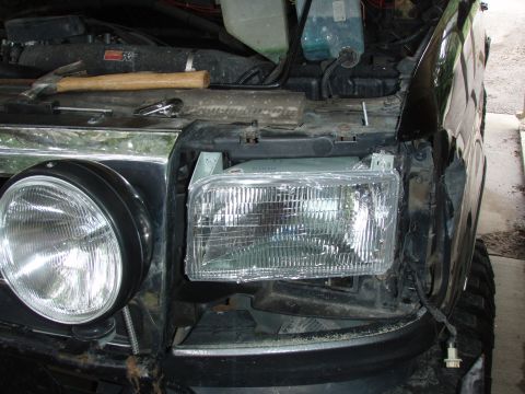 1992 Ford Bronco - inserted the head light into its socket. now would be the time to adjust the screws for allightment.