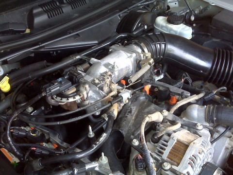 2004 Ford Crown Victoria - Close-up view of the engine bay of a 2004 Ford Crown Victoria, showing various engine components.