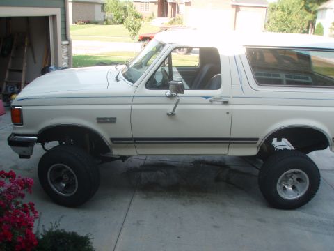 1987 Ford Bronco - This 1987 Ford Bronco is parked in a driveway with a garage in the background.