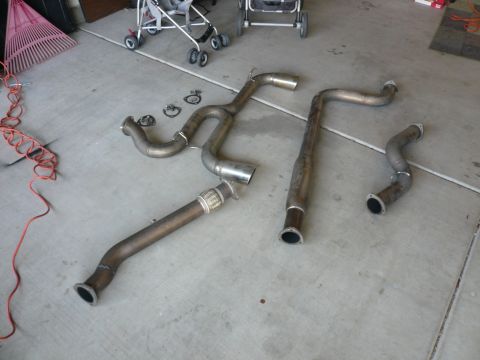 1996 Ford Probe - Several exhaust system components are visible on the ground, including pipes and gaskets.