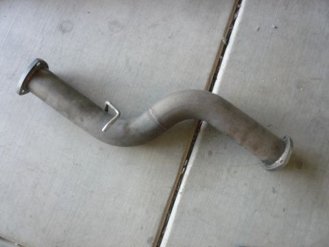 1996 Ford Probe - A single exhaust pipe with flanges on both ends and a metal hanger bracket is shown against a concrete background.