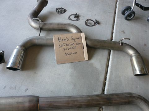 1996 Ford Probe - A close-up of an exhaust system with a handwritten sign indicating its origin and price.