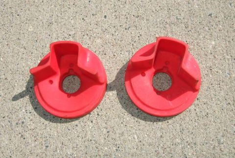1992 Ford Probe - Two red plastic parts are shown on a concrete surface.