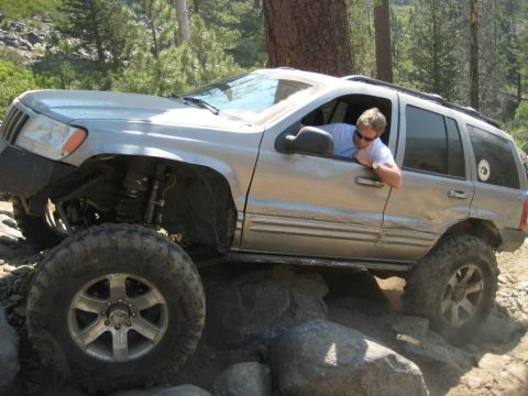 1999 Jeep Grand Cherokee - A silver 1999 Jeep Grand Cherokee navigates a rocky trail.