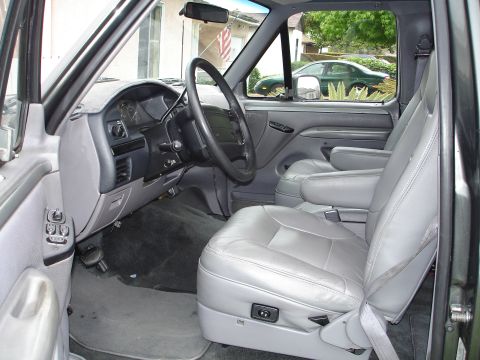 1994 Ford Bronco - Interior view of a 1994 Ford Bronco, gray leather seats and dashboard details.
