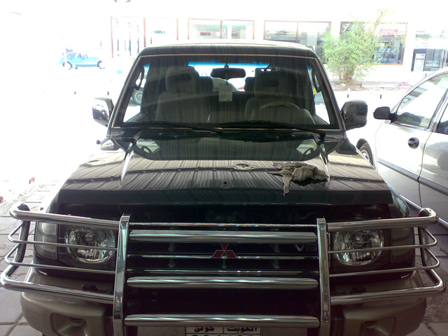 Black SUV front view with chrome bull bar and Mitsubishi badge. Matches 2000 Mitsubishi Montero