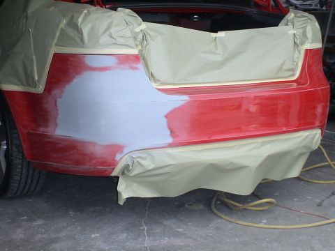 1993 Ford C-350 (Centurion Conversions) - Car bumper area masked for paint repair, showing primer and sanding marks.