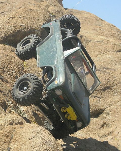 1988 Ford Bronco - A remote-controlled rock crawler vehicle is stuck on a steep, rocky slope.