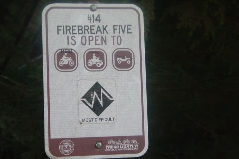1993 Ford Bronco - This sign details trail regulations and difficulty levels for off-road vehicles.