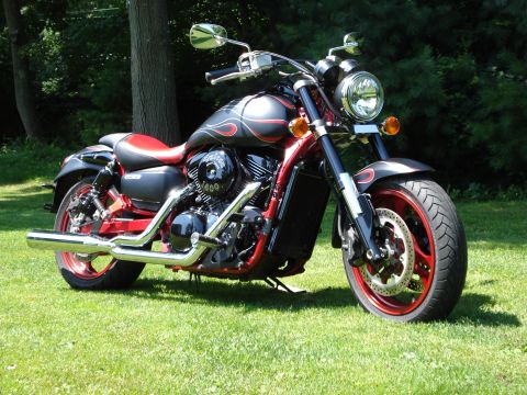 2007 Kawasaki Z1B - A custom motorcycle with flame graphics and red wheels sits on a grassy lawn.