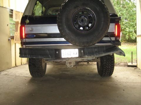 1995 Ford Bronco - The rear of a 1995 Ford Bronco is shown, a spare tire mounted on the tailgate and a trailer hitch.