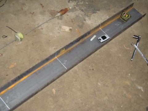 1995 Ford Bronco - A steel beam is marked with measurements, alongside tools and a tennis ball on a rod.