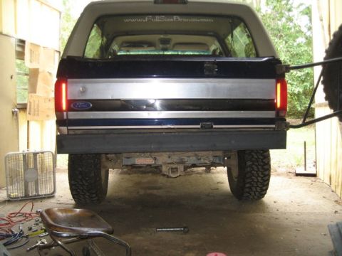 1995 Ford Bronco - The rear of a Ford Bronco is visible, with a website address on the rear window.