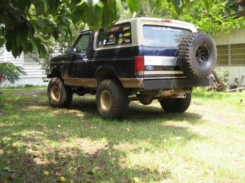 1995 Ford Bronco - Rear view of a 1995 Ford Bronco, a spare tire mounted on the tailgate and a custom bumper.