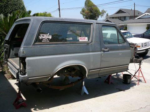 1988 Ford Bronco - This Ford Bronco appears to be undergoing repairs or modifications, with its rear end elevated on jack stands.