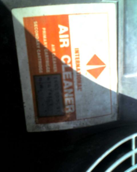 1989 International School Bus - A close-up of a label indicates it is an International air cleaner with details about its cartridges.