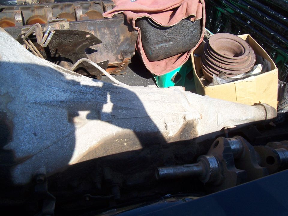 Transmission and engine block parts piled in a truck bed