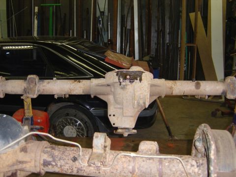 1996 Ford Bronco - Close-up view of a rusty rear axle assembly, likely from a truck or SUV.