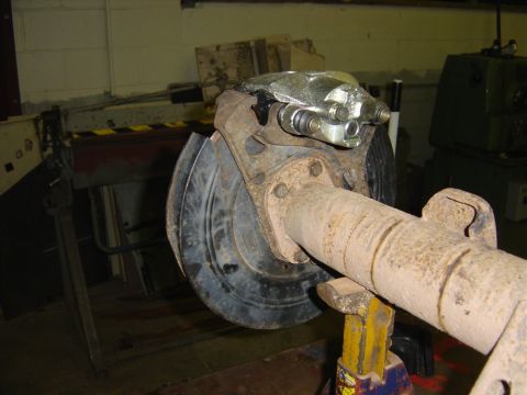 1996 Ford Bronco - A close-up view of a vehicle's rear axle assembly, focusing on the disc brake components.