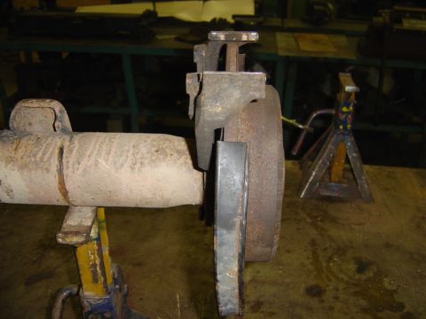 1996 Ford Bronco - A close-up view of a vehicle's rear axle and brake assembly, supported by jack stands.