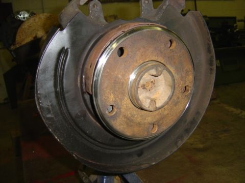 1996 Ford Bronco - Close-up of a rusty brake rotor and hub assembly, likely a vehicle part.