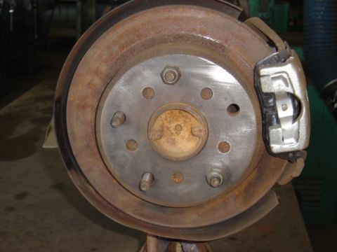 1996 Ford Bronco - Rusty rear brake rotor and caliper assembly shown in detail.