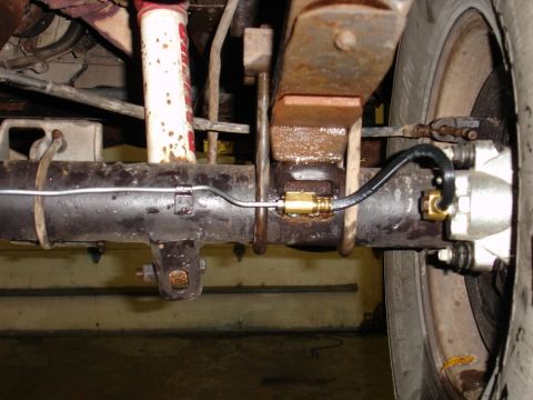 1996 Ford Bronco - Rear axle assembly showing brake caliper, suspension, and brake line routing.