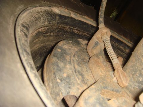 1996 Ford Bronco - Close-up view of a vehicle's rear brake system, showing the rotor, caliper, and suspension parts.