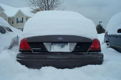 1991 Ford Crown Victoria LTD - Rear of a Ford Crown Victoria buried in snow during winter.