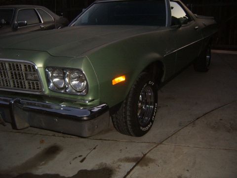 1973 Ford Ranchero - A green 1972 Ford Ranchero is viewed from the front three-quarter angle at night.