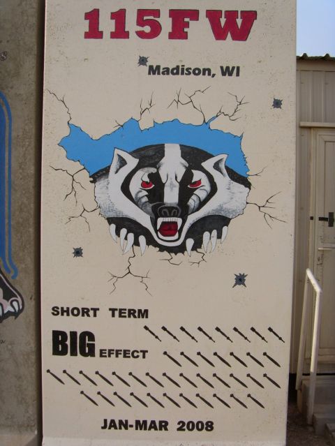 1978 Ford Bronco - A mural depicts a badger's head bursting through a cracked wall, accompanied by text and bomb graphics.