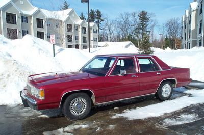 1991 Ford Crown Victoria LTD - This 1991 Ford Crown Victoria LTD sedan is seen parked in a snowy lot, likely during winter.