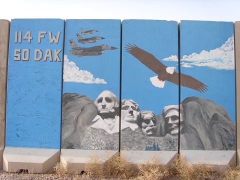 1978 Ford Bronco - Concrete barriers are painted with patriotic imagery including Mount Rushmore, fighter jets, and a bald eagle.