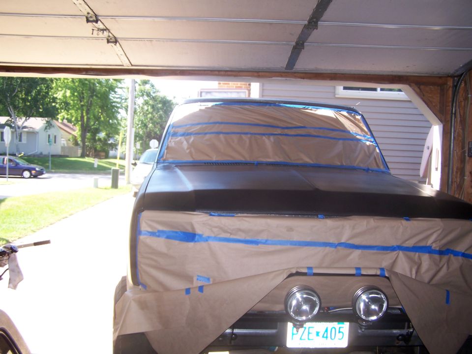 1986 Ford Bronco front end masked for painting, showing headlights and license plate