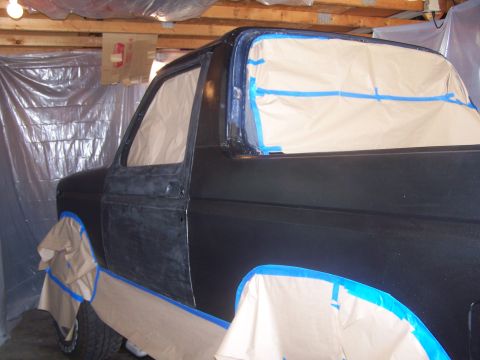 1986 Ford Bronco - Ford Bronco bodywork in progress, masked for paint application in a workshop environment.