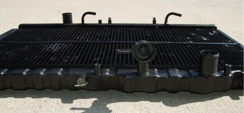 1992 Ford Probe - A black car radiator is shown from the front, resting on a concrete surface.