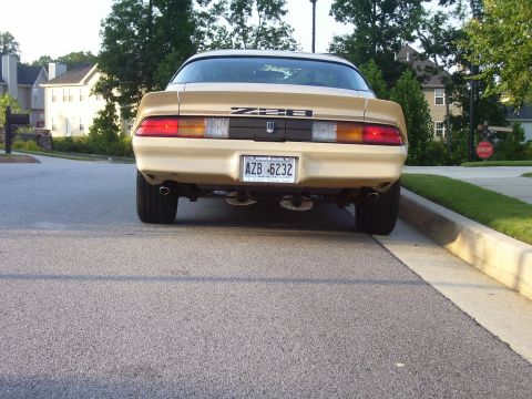 1979 Chevrolet Camaro - Rear view of a gold 1979 Chevrolet Camaro Z28 parked on a residential street.