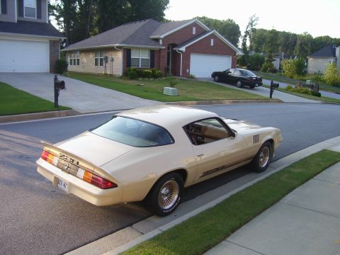 1979 Chevrolet Camaro - A 1979 Chevrolet Camaro Z28 is parked on the street in front of a house, with another car in the driveway.