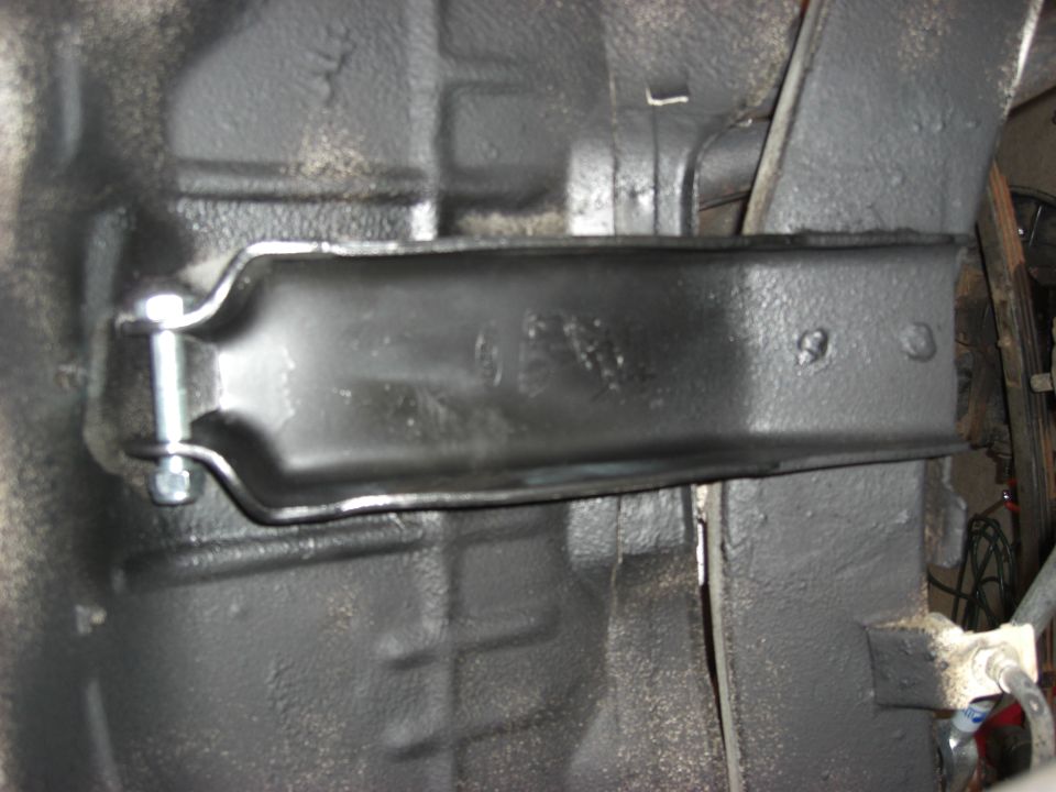 Black skid plate bracket bolted under freshly undercoated chassis of Suzuki Samurai