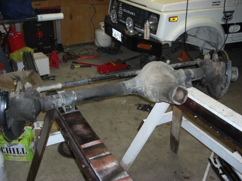 1987 Suzuki Samurai - Front axle assembly from a 1987 Suzuki Samurai, with the vehicle visible in the background.