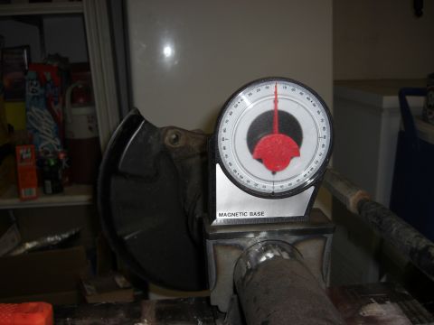 1987 Suzuki Samurai - A magnetic base angle gauge is used to measure the angle of a metal pipe, possibly for automotive work.