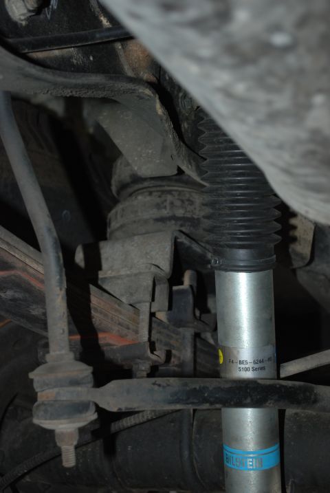 1994 Ford Bronco - Underneath view of the rear suspension system, showing leaf springs and a shock absorber.