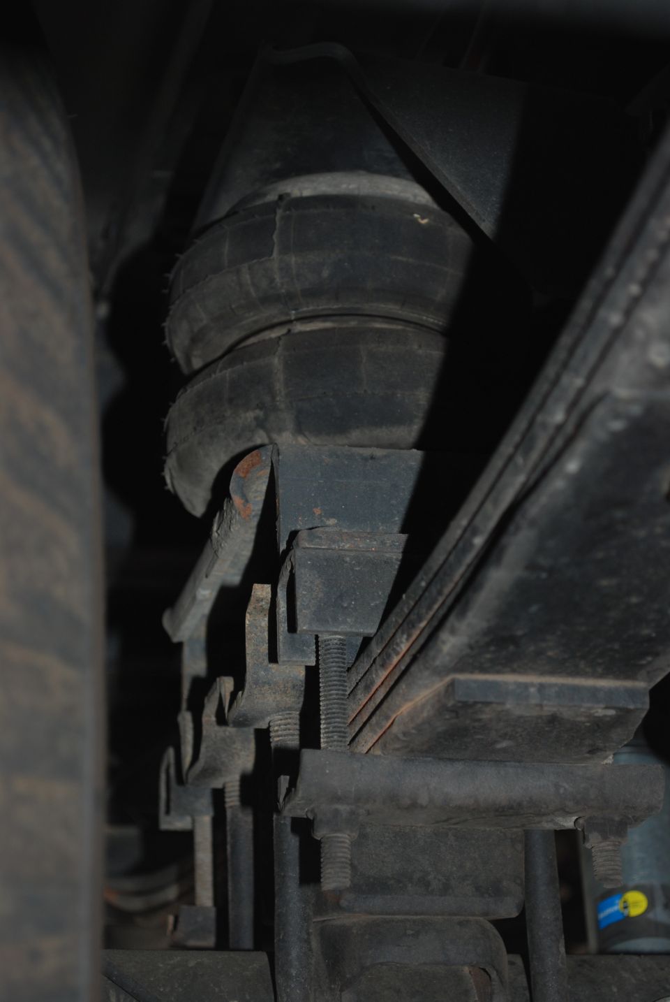 Close-up of an air suspension bellows and leaf spring assembly