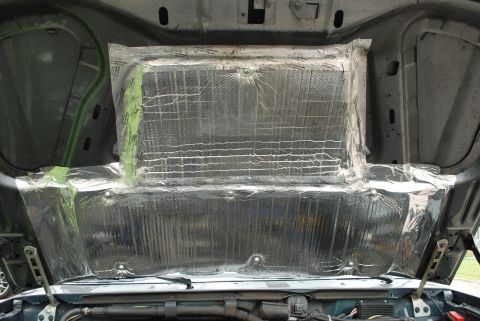 1994 Ford Bronco - The underside of a vehicle's hood has been lined with reflective insulation material.