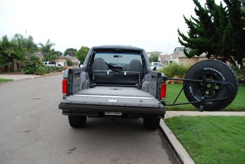 1994 Ford Bronco - This 1994 Ford Bronco is viewed from the rear, showing its spare tire carrier mounted externally.