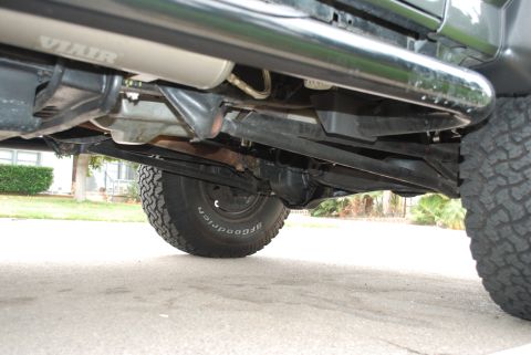 1994 Ford Bronco - The underside of a vehicle is shown, revealing its suspension and exhaust system.