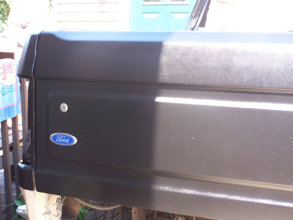 Ford emblem on black rear quarter panel of a Bronco